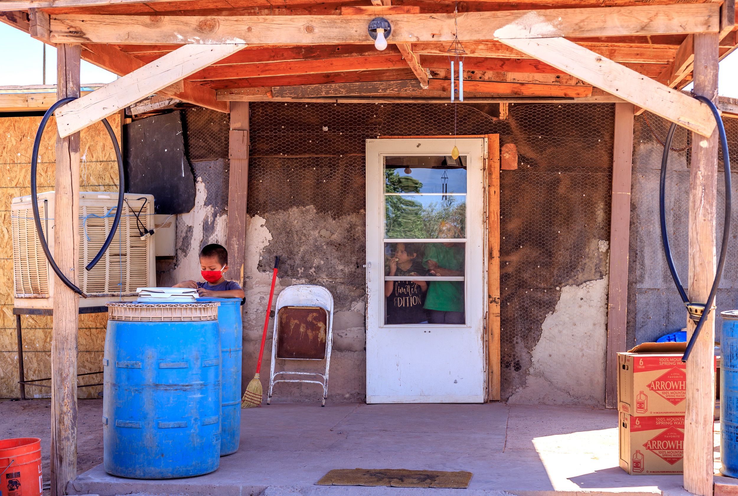 Children in Chinle, Ariz., wait for a delivery of water and supplies from the Johns Hopkins Center for American Indian Health. 